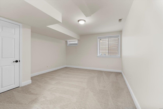 unfurnished room with light colored carpet and baseboards