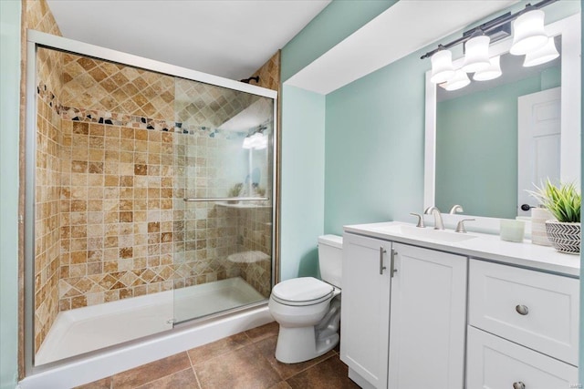 bathroom featuring vanity, toilet, a stall shower, and tile patterned flooring