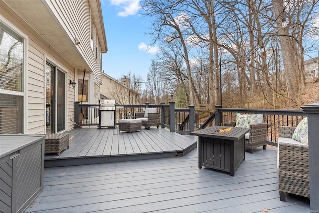 wooden deck with an outdoor living space with a fire pit