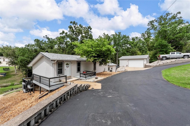 view of front of home with an outdoor structure and a detached garage