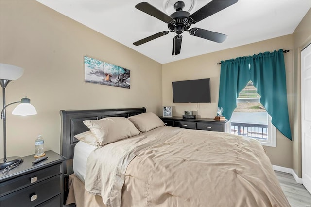 bedroom with baseboards, ceiling fan, and light wood finished floors