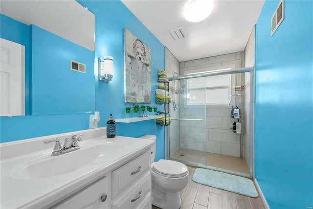 full bath featuring toilet, a stall shower, and visible vents