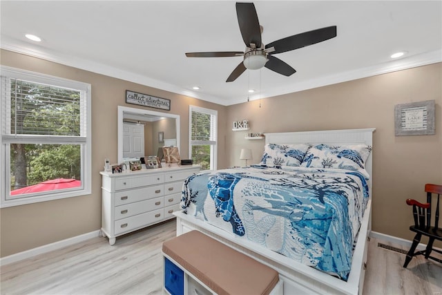 bedroom with light wood-style floors, recessed lighting, crown molding, and baseboards