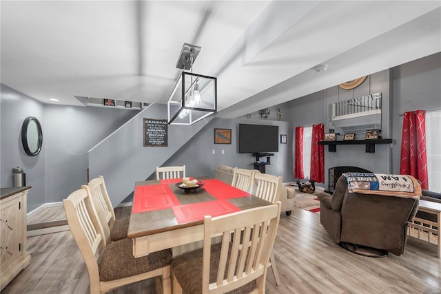 dining space with light wood finished floors and baseboards