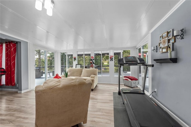 exercise area featuring wood finished floors and baseboards