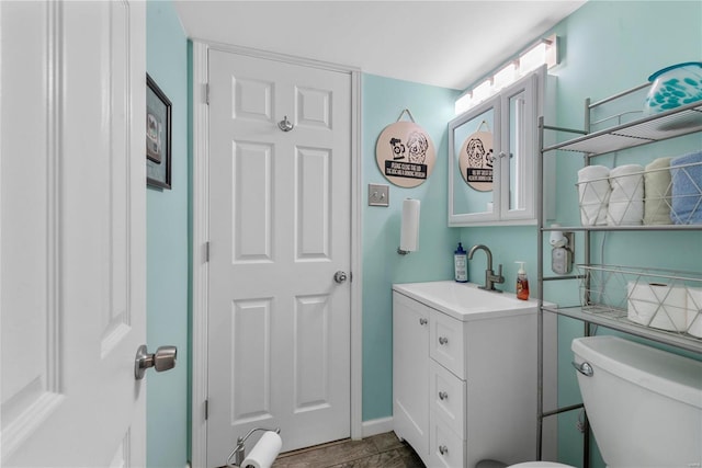 bathroom with toilet and vanity
