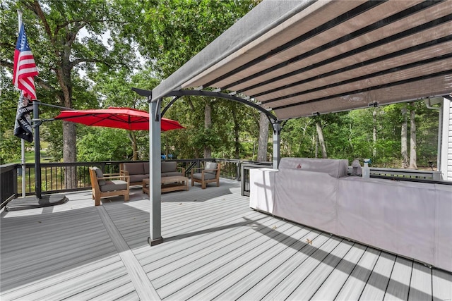 wooden deck with a pergola and an outdoor hangout area