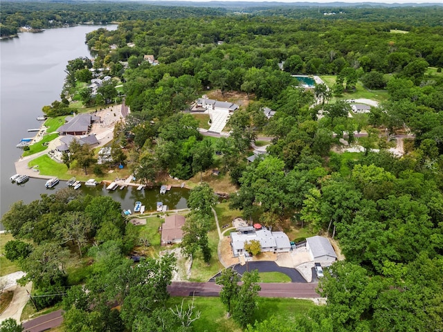 drone / aerial view with a water view and a wooded view