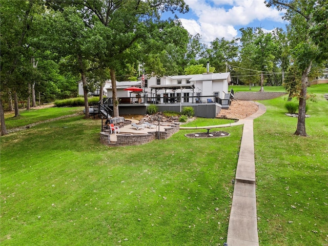 view of yard featuring a patio area and a wooden deck