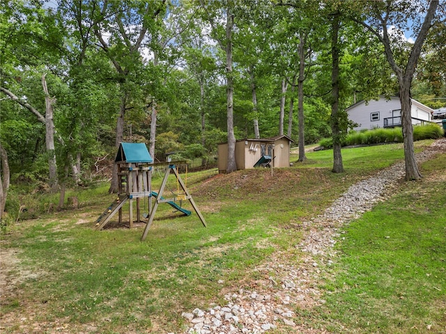 view of yard with a shed, a playground, and an outbuilding