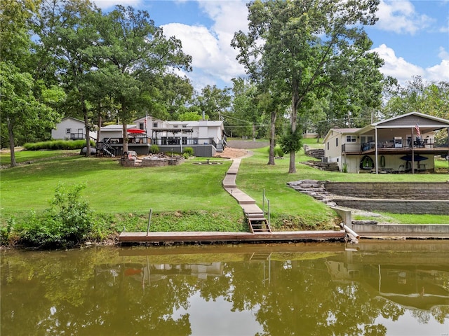 view of community with a deck with water view and a yard