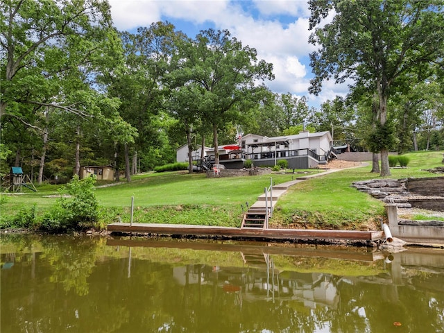dock area featuring a yard, stairway, and a deck with water view