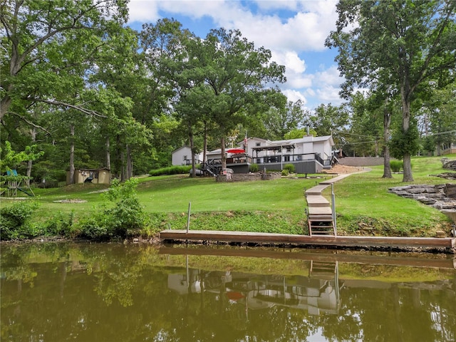 dock area with stairway, a lawn, and a deck with water view