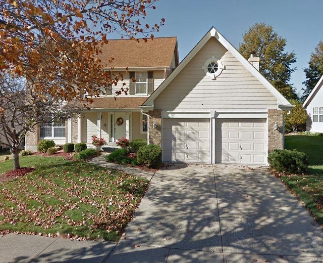 view of front facade featuring a garage and a front lawn