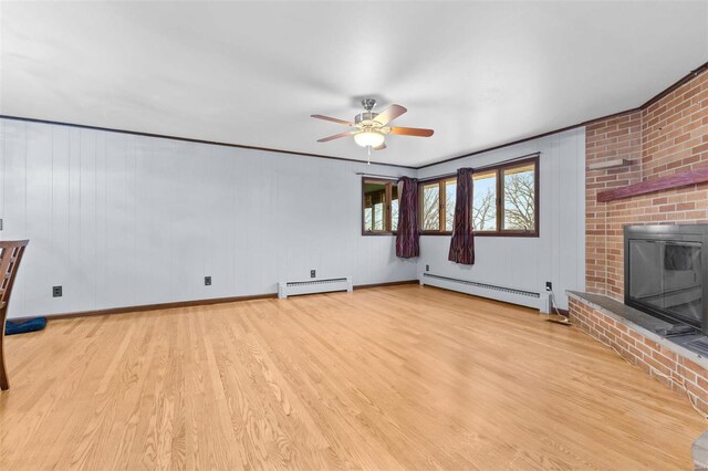 unfurnished living room with ceiling fan, a fireplace, light wood-type flooring, and a baseboard heating unit