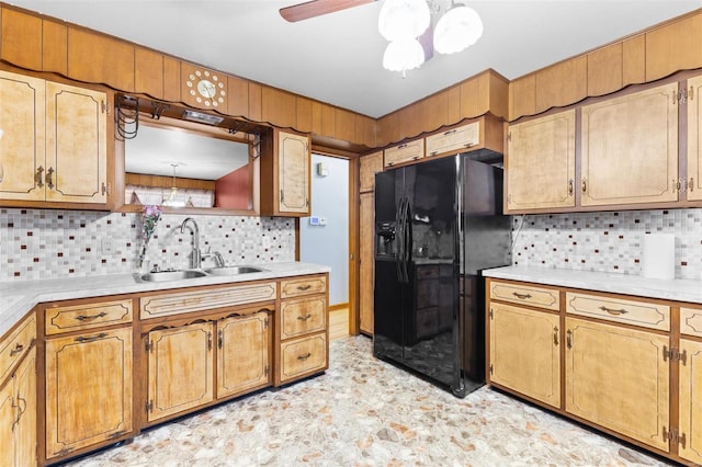 kitchen with tasteful backsplash, ceiling fan, sink, and black fridge with ice dispenser