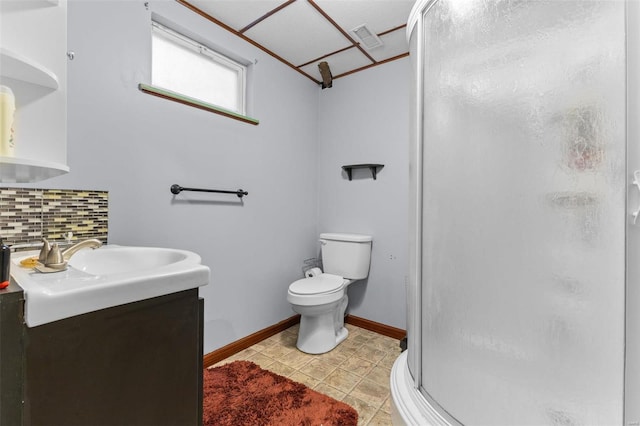 bathroom featuring walk in shower, vanity, toilet, and backsplash