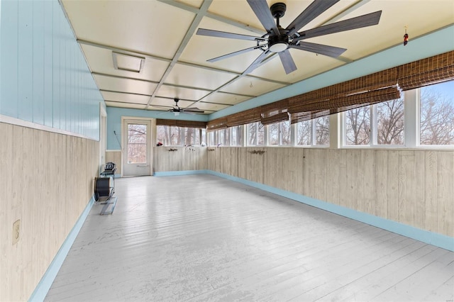 unfurnished sunroom with ceiling fan