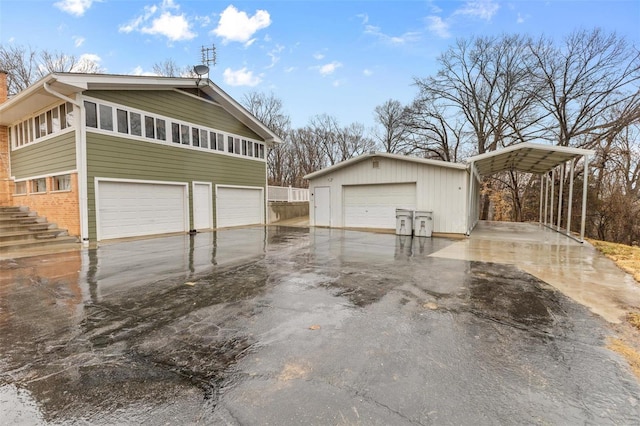 view of side of home with an outbuilding, a carport, and a garage