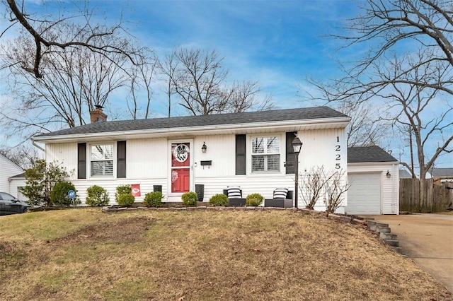 view of front of home with a front lawn, fence, concrete driveway, a garage, and a chimney