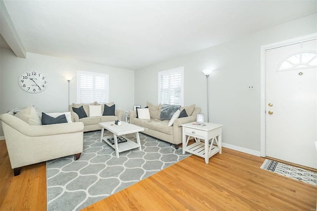 living room featuring wood finished floors and baseboards