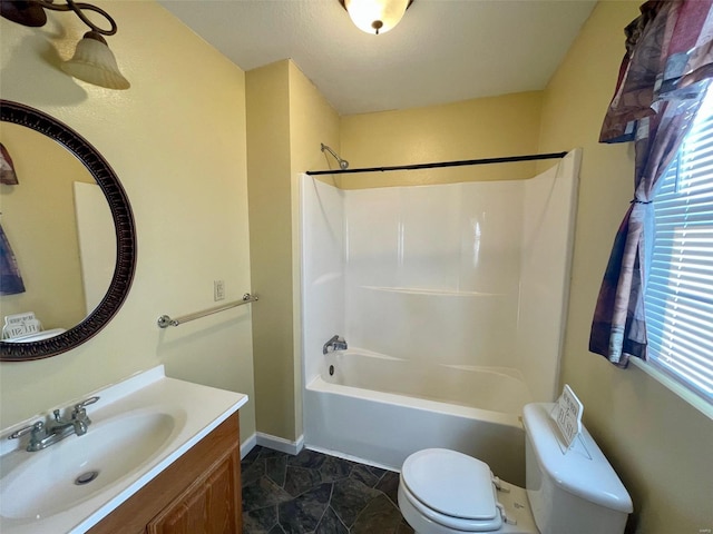 full bathroom featuring shower / tub combination, vanity, toilet, and a wealth of natural light