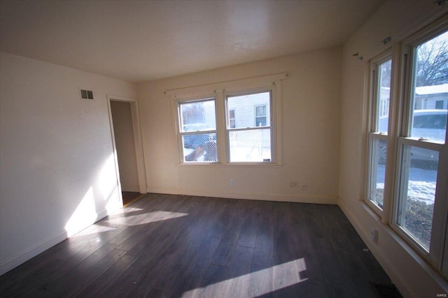 spare room featuring dark hardwood / wood-style flooring