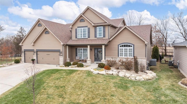 craftsman inspired home featuring a front lawn, fence, concrete driveway, central AC, and an attached garage