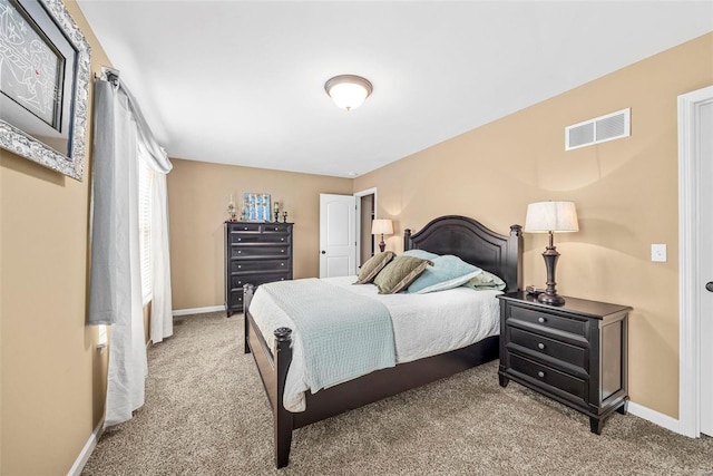 carpeted bedroom featuring visible vents and baseboards