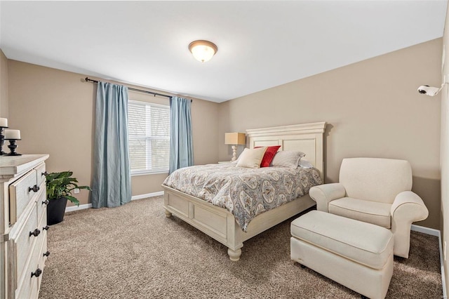 bedroom with baseboards and light colored carpet