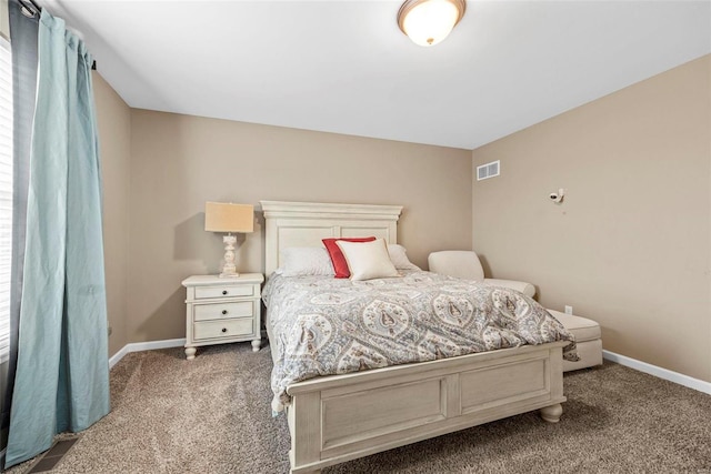 carpeted bedroom featuring baseboards and visible vents