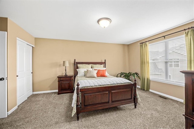 bedroom featuring visible vents, baseboards, and light carpet