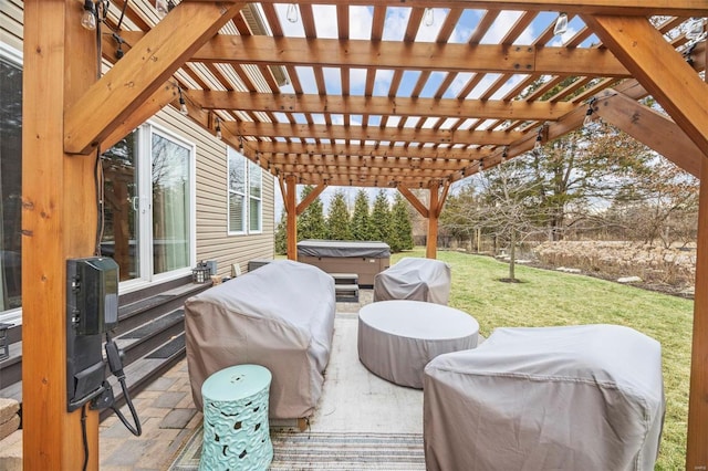 view of patio / terrace with area for grilling and a hot tub