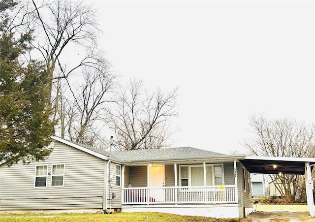 ranch-style house with a carport and a porch