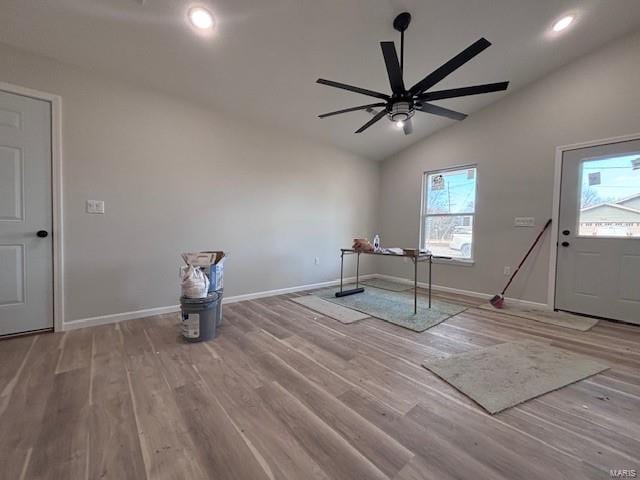 interior space with wood-type flooring, lofted ceiling, and ceiling fan