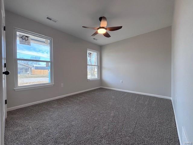 carpeted spare room with ceiling fan