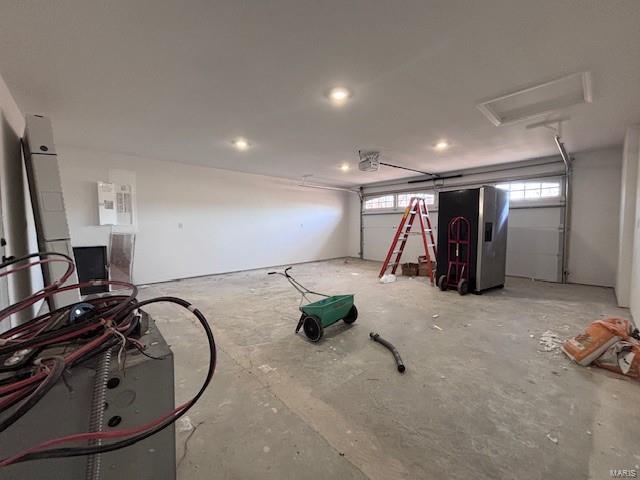 garage featuring stainless steel refrigerator with ice dispenser