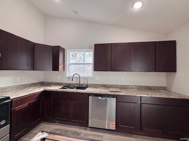 kitchen featuring lofted ceiling, sink, dark brown cabinets, and stainless steel appliances