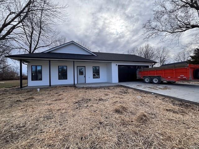 view of front of home with a garage and covered porch