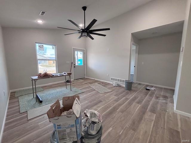 interior space with lofted ceiling, wood-type flooring, and ceiling fan