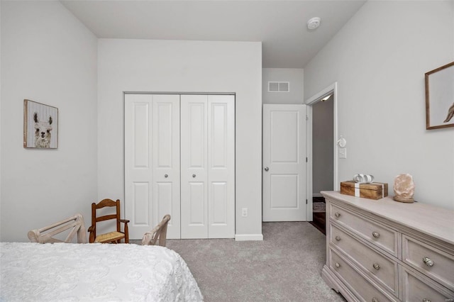 bedroom featuring light carpet and a closet