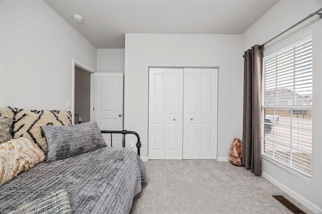 bedroom with carpet floors and a closet