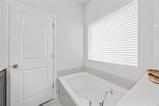 bathroom featuring vanity and a tub