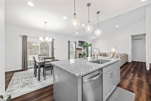 kitchen with a kitchen island with sink, sink, decorative light fixtures, and stainless steel dishwasher