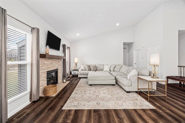 living room with a fireplace, dark hardwood / wood-style flooring, and high vaulted ceiling