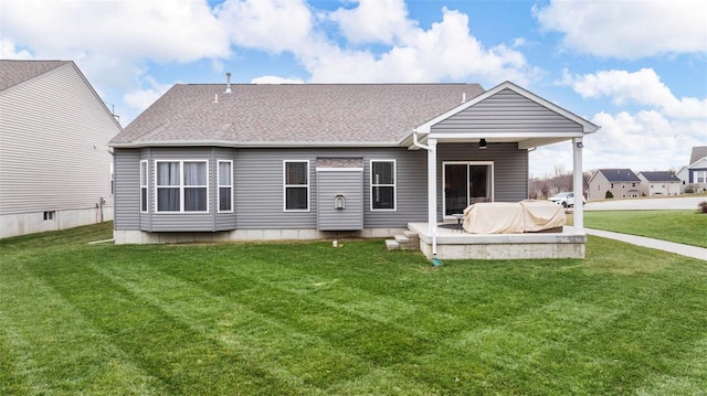 rear view of house featuring a patio and a yard