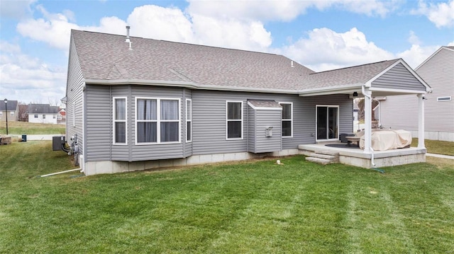 back of property featuring central AC unit, a yard, and a patio