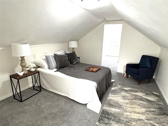 bedroom with lofted ceiling and dark carpet