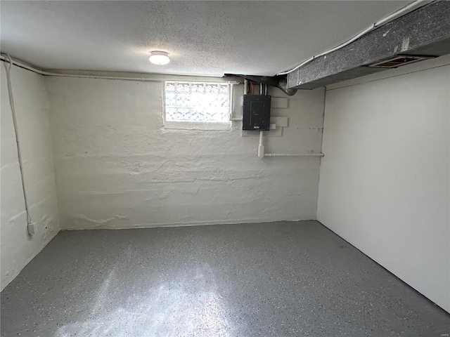 basement with electric panel and a textured ceiling