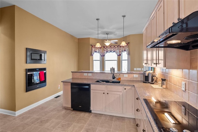 kitchen featuring backsplash, a sink, a peninsula, under cabinet range hood, and black appliances